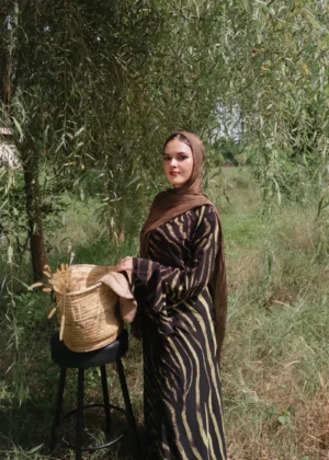 Women's black maxi dress with olive green abstract zebra print, long sleeves, bold nature-inspired modest wear.